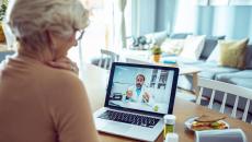 A person talking to a doctor via video call on her laptop.